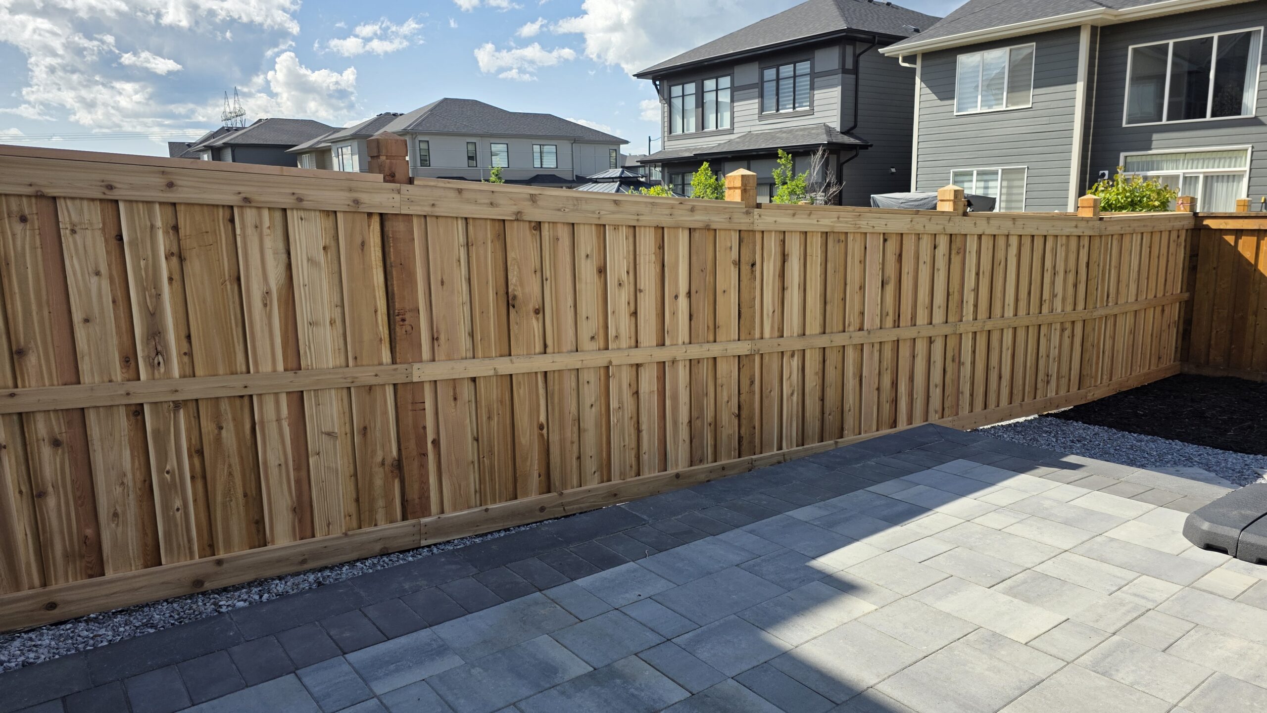Cedar privacy fence with decorative post caps built by Crestfield Decking in Edmonton, Alberta