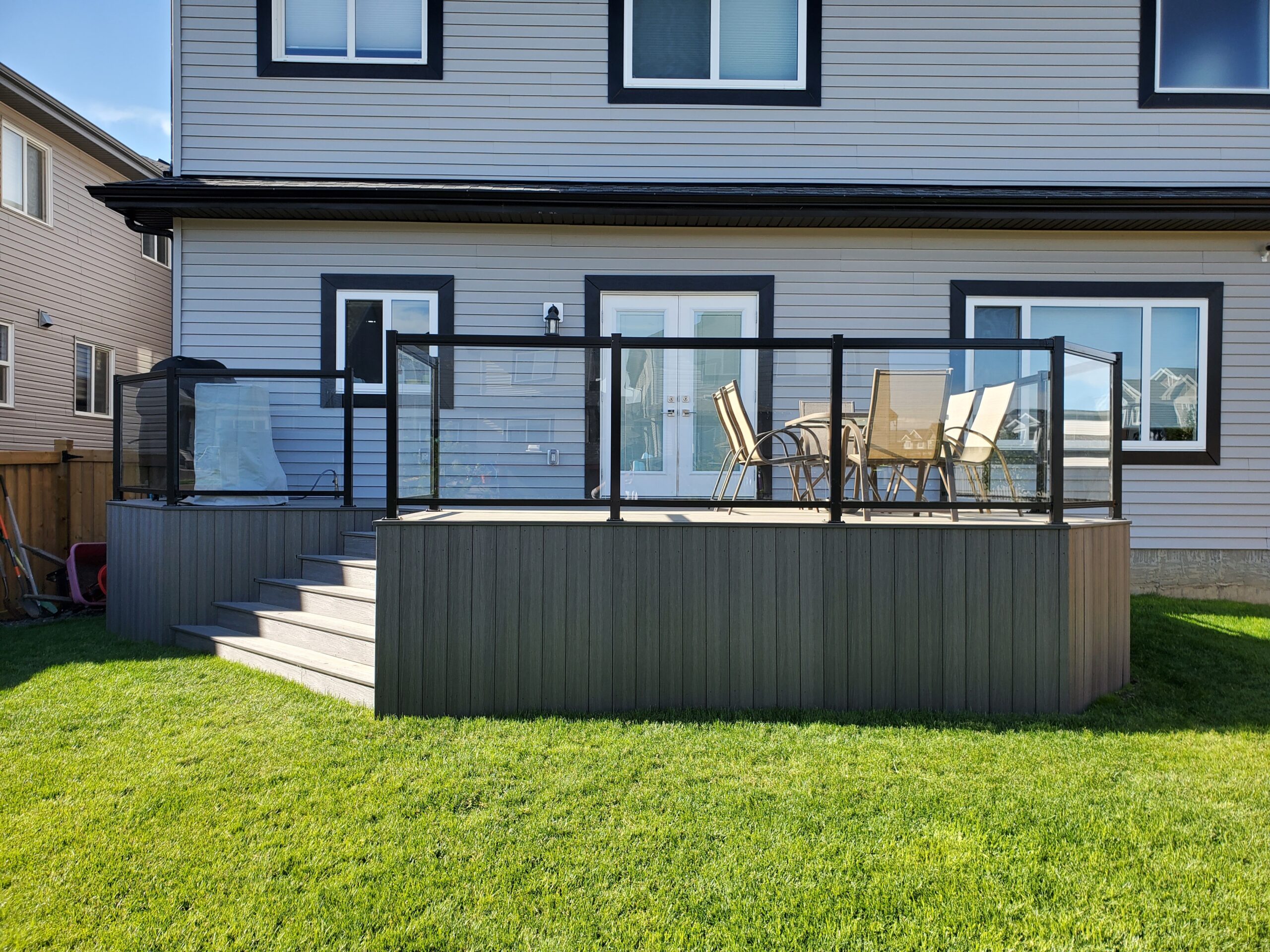 Composite deck with aluminum and glass railing built by Crestfield Decking in Edmonton, Alberta