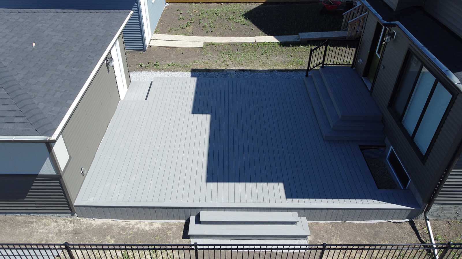 Aerial view of grey composite deck covering full backyard built by Crestfield Decking in Edmonton, Alberta