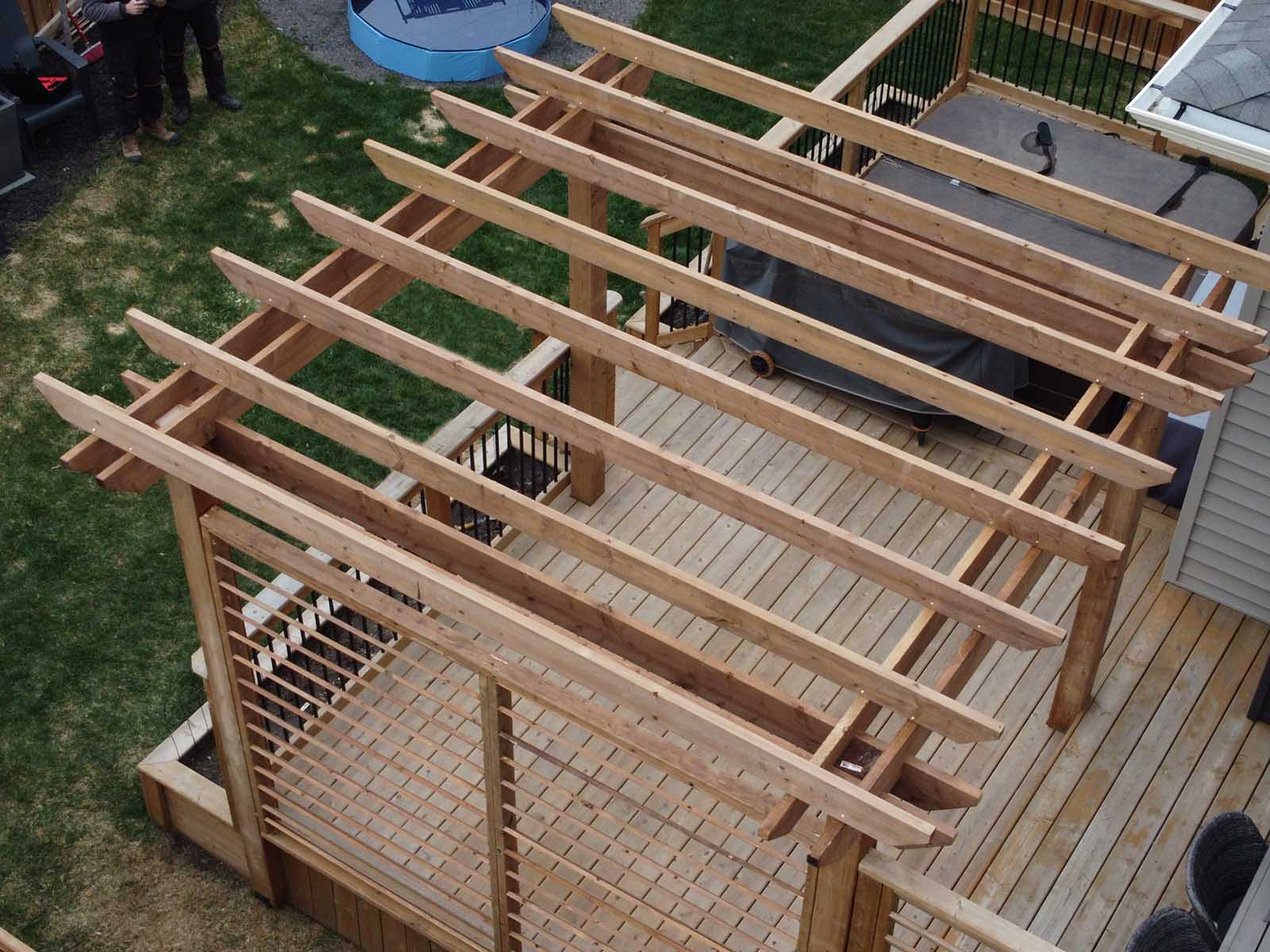 Pressure treated custom pergola with privacy screen built by Crestfield Decking in Edmonton, Alberta