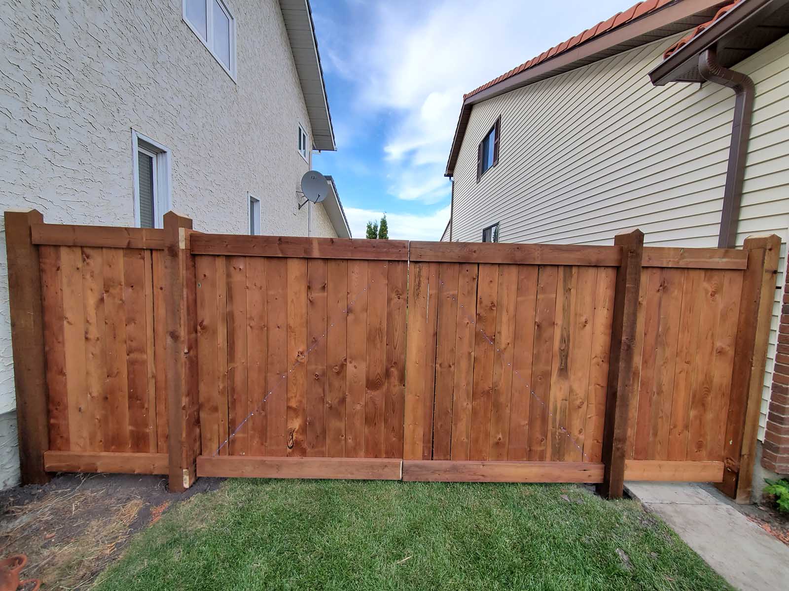 Pressure-treated double gate as part of privacy fence built by Crestfield Decking in Edmonton, Alberta